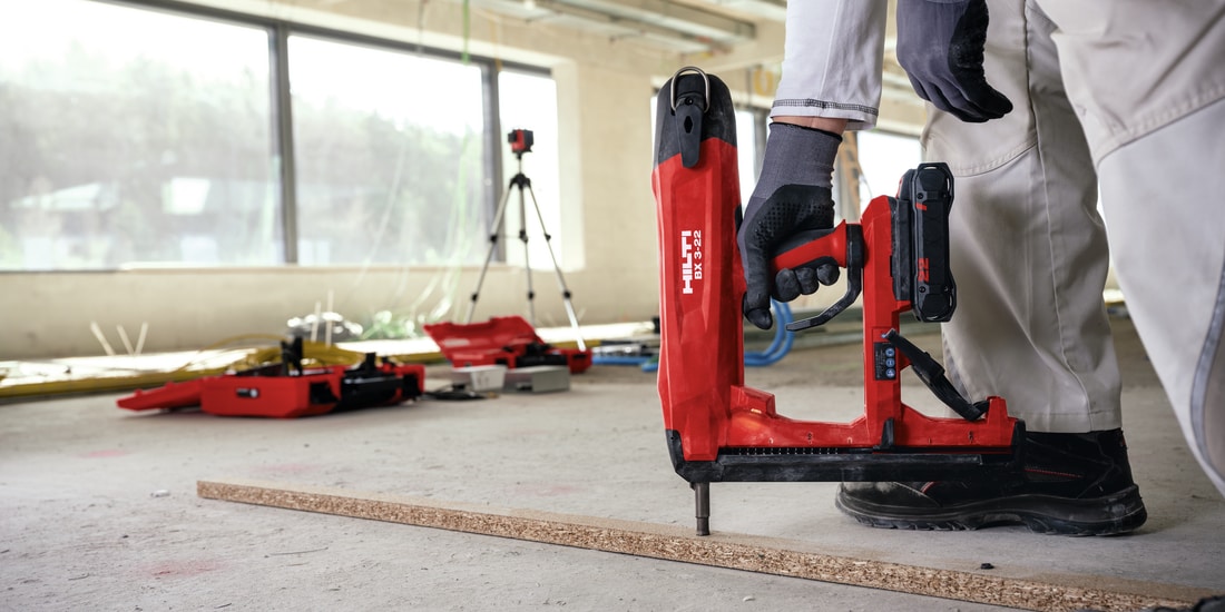 BX 3 battery-powered nailer, a virtually dust-free alternative to drilling, being used to fasten on concrete